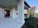 Inviting front porch features stately columns and a stylish front door with sidelights at 7606 Loon Ave, Winter Garden, FL 34787