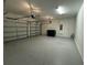 Spacious three-car garage with a clean, epoxy-coated floor offers ample parking and storage space at 7606 Loon Ave, Winter Garden, FL 34787