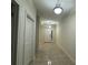 Long hallway with tiled flooring, white trim, and recessed lighting at 7606 Loon Ave, Winter Garden, FL 34787