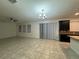 Open-concept living room featuring tile flooring and a modern chandelier at 7606 Loon Ave, Winter Garden, FL 34787