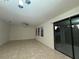 Spacious living room with sliding glass doors to back patio at 7606 Loon Ave, Winter Garden, FL 34787