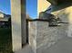 Close-up of a built-in stone grill on a covered patio, ideal for outdoor cooking at 7606 Loon Ave, Winter Garden, FL 34787