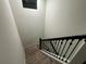 Top of the staircase with carpeted steps and dark handrail at 7606 Loon Ave, Winter Garden, FL 34787