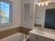 Bathroom features a soaking tub, vanity and a large window at 8266 Tavistock Lakes Blvd, Orlando, FL 32827