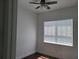 Cozy bedroom features hardwood floors, ceiling fan and large window at 8266 Tavistock Lakes Blvd, Orlando, FL 32827