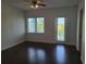 Bedroom with wood floors, ceiling fan and a glass door leading to a balcony at 8266 Tavistock Lakes Blvd, Orlando, FL 32827