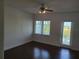 Bedroom with ceiling fan and a glass door leading to a balcony at 8266 Tavistock Lakes Blvd, Orlando, FL 32827