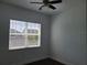 Bright bedroom features hardwood floors, ceiling fan and large window at 8266 Tavistock Lakes Blvd, Orlando, FL 32827