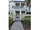 Inviting two-story condo with well-maintained landscaping, a private patio, and a modern pergola entry at 8266 Tavistock Lakes Blvd, Orlando, FL 32827