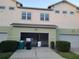 Townhome exterior with attached garage and well-maintained landscaping at 8266 Tavistock Lakes Blvd, Orlando, FL 32827