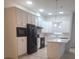 Contemporary kitchen featuring white cabinetry, stainless steel appliances, and a functional island at 8266 Tavistock Lakes Blvd, Orlando, FL 32827