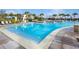 Inviting community pool featuring clear water, sun loungers, and shaded cabanas at 8266 Tavistock Lakes Blvd, Orlando, FL 32827