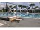 Sparkling community pool featuring swimming lanes, sun loungers, and shaded cabanas at 8266 Tavistock Lakes Blvd, Orlando, FL 32827