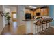 Bright kitchen with wooden cabinets, granite countertops, and seating at the breakfast bar at 9114 Stromboli Ct, Kissimmee, FL 34747