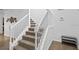 Carpeted staircase with a white railing and neutral colors at 9114 Stromboli Ct, Kissimmee, FL 34747