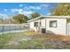 A backyard featuring a pool with safety fence and a home with green trim and an AC unit at 10526 Fernando St, Orlando, FL 32825