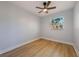 This bedroom features luxury vinyl plank flooring, a ceiling fan, and a window at 10526 Fernando St, Orlando, FL 32825