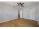 This bedroom features luxury vinyl plank flooring, a ceiling fan, and a closet at 10526 Fernando St, Orlando, FL 32825