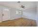 Clean, bright bedroom featuring modern flooring, fresh paint, and a ceiling fan at 10526 Fernando St, Orlando, FL 32825