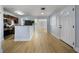 Bright living area adjacent to kitchen, featuring modern flooring and neutral paint at 10526 Fernando St, Orlando, FL 32825