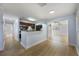 Bright, open-concept living space with modern flooring, connecting kitchen and living area at 10526 Fernando St, Orlando, FL 32825