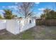 A white shed with double doors and a window is located in the back yard of this home at 10526 Fernando St, Orlando, FL 32825