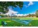 An outdoor basketball court surrounded by lush greenery and blue skies provides an area for recreation at 10742 Boca Pointe Dr, Orlando, FL 32836