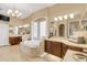 Luxurious bathroom with a jacuzzi tub, double vanity sinks, and ceramic tile at 10742 Boca Pointe Dr, Orlando, FL 32836