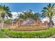 Entrance to Turtle Creek featuring lush landscaping and an ornate brick sign at 10742 Boca Pointe Dr, Orlando, FL 32836
