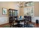 Formal dining room featuring a modern chandelier, hardwood floors and plenty of natural light at 10742 Boca Pointe Dr, Orlando, FL 32836