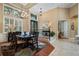 Open dining room featuring hardwood floors, plantation shutters, modern lighting and an entryway at 10742 Boca Pointe Dr, Orlando, FL 32836