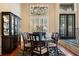 Traditional dining room with a dark wood table, hardwood floors and modern chandelier lighting at 10742 Boca Pointe Dr, Orlando, FL 32836