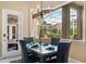 Dining room features a modern chandelier and views of the screened-in patio at 10742 Boca Pointe Dr, Orlando, FL 32836