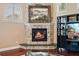Living room fireplace with stone surround, framed art, and media center at 10742 Boca Pointe Dr, Orlando, FL 32836