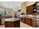 Gourmet kitchen with granite countertops, dark wood cabinetry, and stainless steel appliances at 10742 Boca Pointe Dr, Orlando, FL 32836
