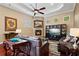 Spacious living room with brick fireplace, ceiling fan, and hardwood floors at 10742 Boca Pointe Dr, Orlando, FL 32836