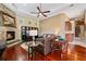 Open living room with fireplace, sofas, hardwood floors, and bar area at 10742 Boca Pointe Dr, Orlando, FL 32836