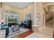 Inviting living area with a piano, comfortable seating, and access to the outdoor pool area at 10742 Boca Pointe Dr, Orlando, FL 32836