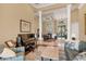 Elegant living room open to dining area with tile flooring, tall windows, and tasteful decor at 10742 Boca Pointe Dr, Orlando, FL 32836