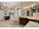 Luxurious bathroom with a large soaking tub, dual vanities, and elegant tilework at 10742 Boca Pointe Dr, Orlando, FL 32836