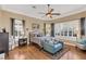 Bright main bedroom with hardwood floors, tray ceiling, and plantation shutters at 10742 Boca Pointe Dr, Orlando, FL 32836