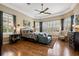 Spacious main bedroom suite with hardwood floors, tray ceiling, and serene natural light from large windows at 10742 Boca Pointe Dr, Orlando, FL 32836