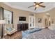 Bright main bedroom with hardwood floors, tray ceiling, and a seating area at 10742 Boca Pointe Dr, Orlando, FL 32836