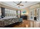 Sun-drenched main bedroom features hardwood floors, plantation shutters, and access to the outdoors at 10742 Boca Pointe Dr, Orlando, FL 32836