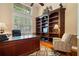 Spacious office with a hardwood floors, a bookshelf and a large desk at 10742 Boca Pointe Dr, Orlando, FL 32836