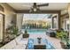 Covered patio with comfortable seating and views of the pool and screened-in lanai at 10742 Boca Pointe Dr, Orlando, FL 32836