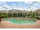 A screened-in pool with an attached spa and brick paver decking offers a refreshing outdoor experience at 10742 Boca Pointe Dr, Orlando, FL 32836