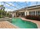 A screened-in pool with an attached spa and lush landscaping offers privacy and relaxation at 10742 Boca Pointe Dr, Orlando, FL 32836