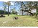 Large backyard with treehouse, seating area, and lush greenery at 1109 Brownshire Ct, Longwood, FL 32779