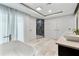 A modern bathroom with white and gray tile, featuring a soaking tub and a glass-enclosed shower at 1109 Brownshire Ct, Longwood, FL 32779